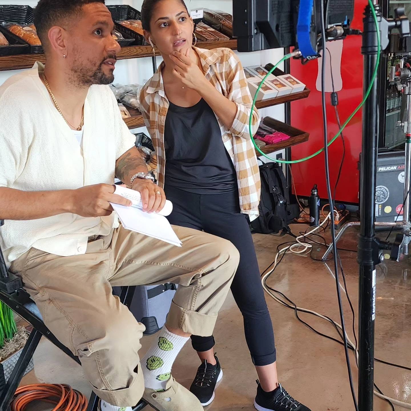 Creative professionals reviewing production equipment together