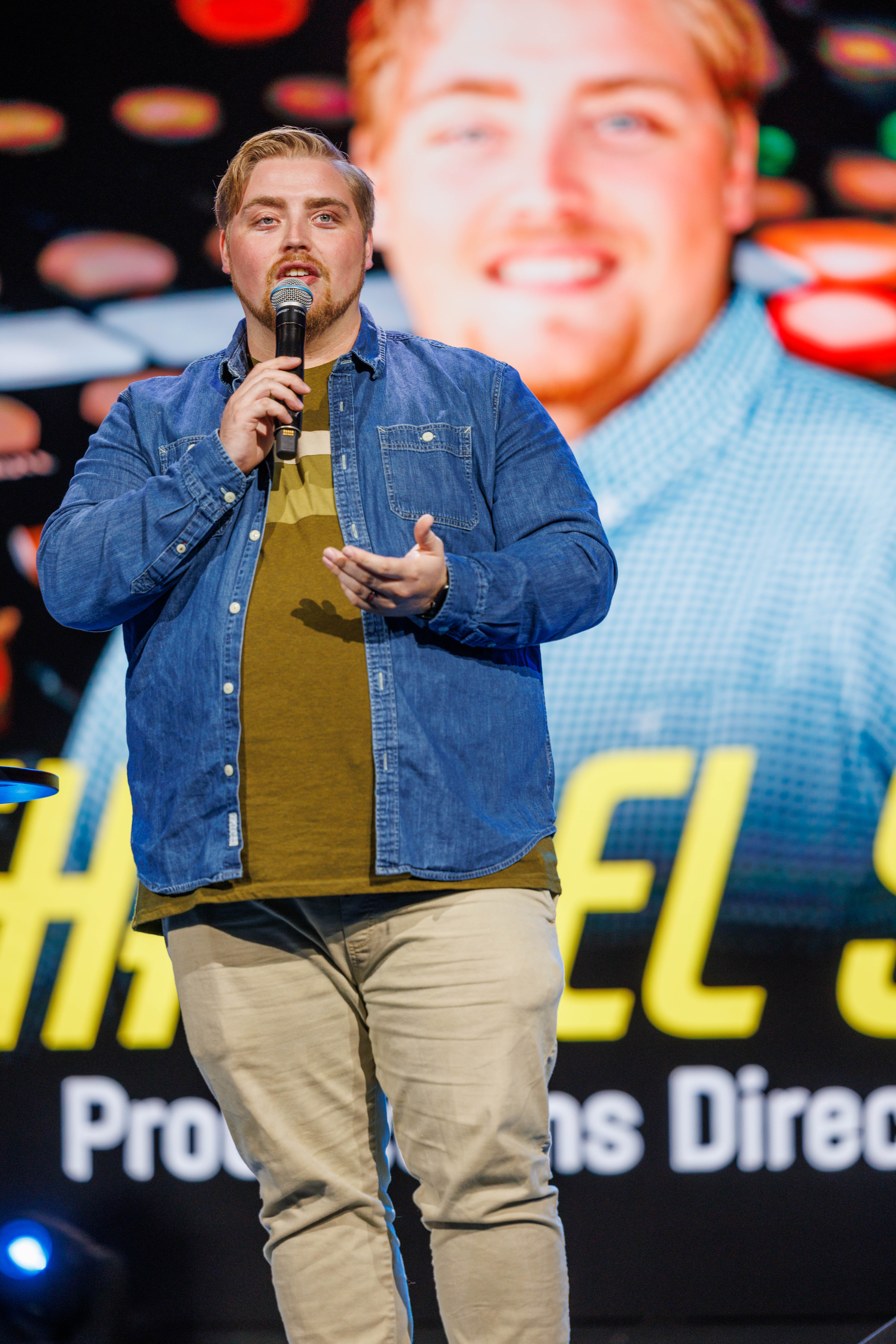 A conference speaker sharing insight from the main stage