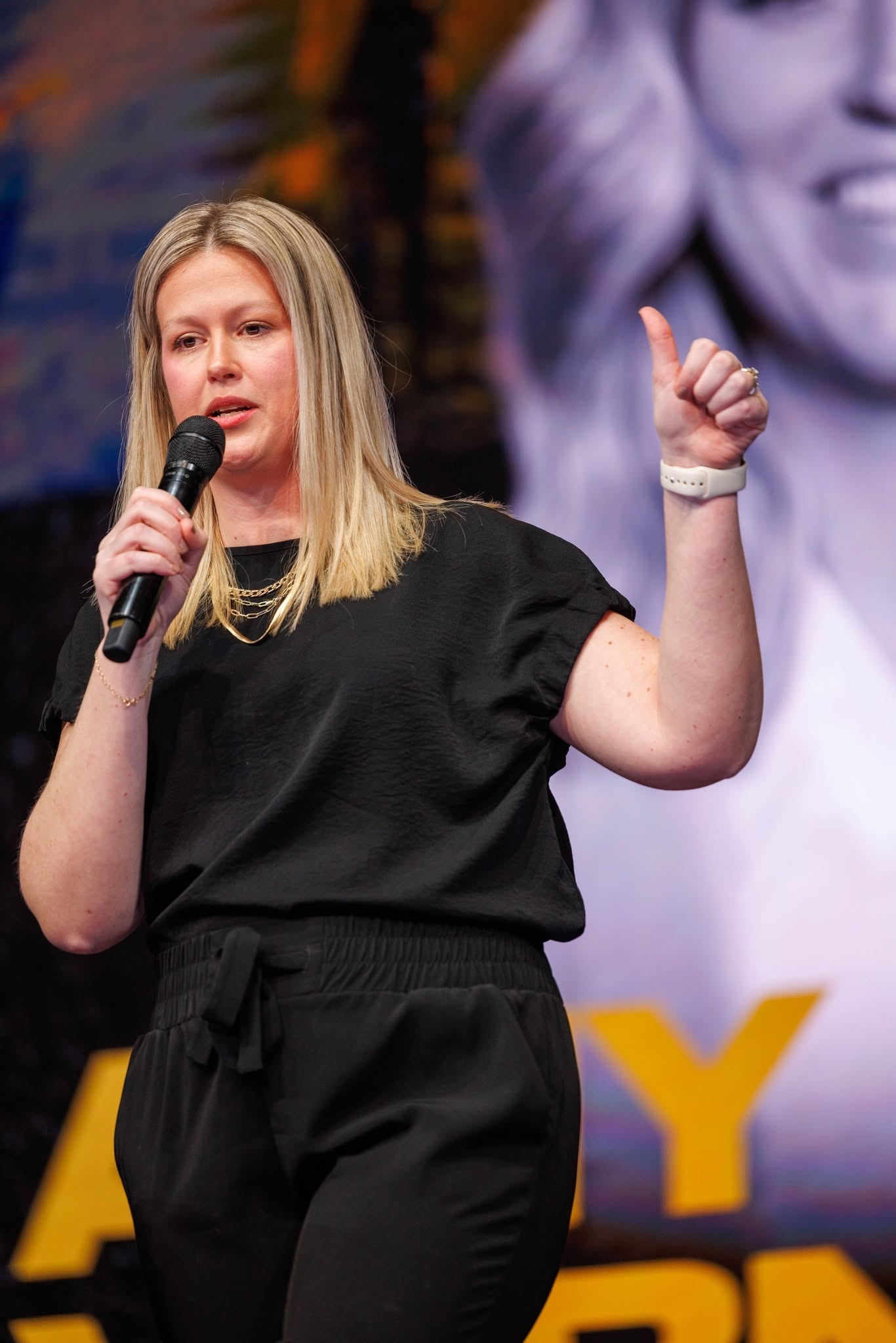 A conference speaker sharing practical insight from the stage